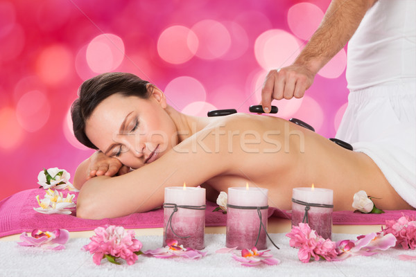 Relaxed Woman Receiving Hot Stone Therapy Stock photo © AndreyPopov