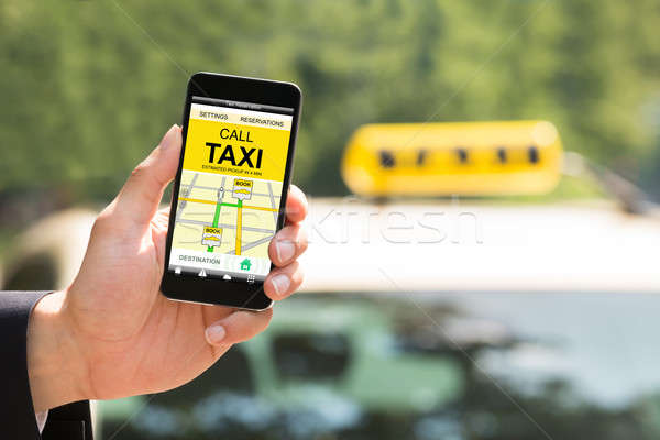 Person Hand Holding Mobile Phone Booking Taxi Stock photo © AndreyPopov