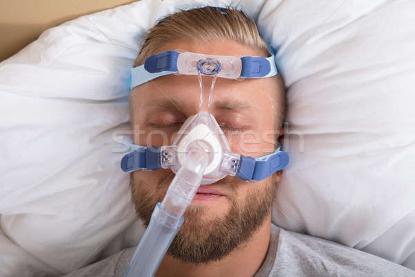 Man With Sleeping Apnea And CPAP Machine Stock photo © AndreyPopov