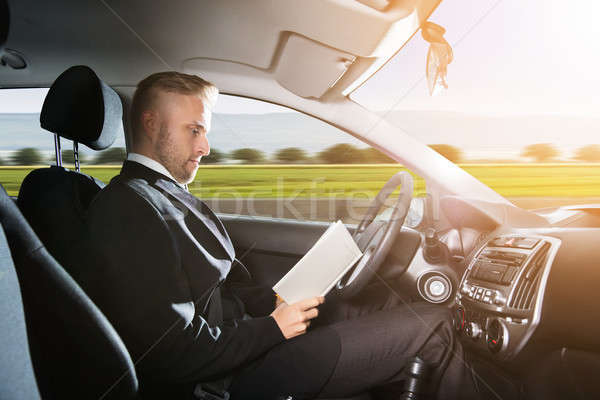 Businessman Sitting Inside Self Driving Car Stock photo © AndreyPopov