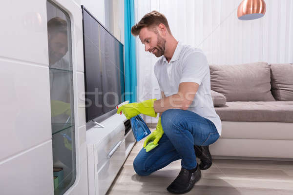Man Cleaning Furniture With Spray Bottle Stock photo © AndreyPopov