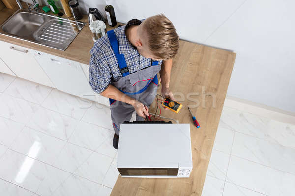 Male Technician Checking Microwave Stock photo © AndreyPopov