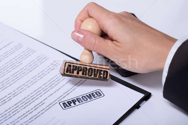 Person Hands Using Stamper On Document With The Text Approved Stock photo © AndreyPopov