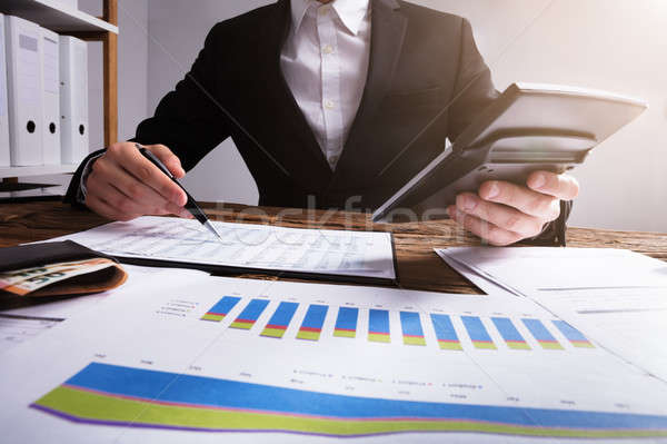 [[stock_photo]]: Homme · d'affaires · graphiques · portefeuille · bois · bureau