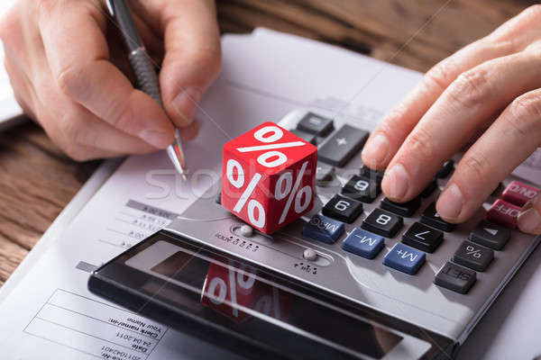Businessperson Calculating Invoice With Calculator Stock photo © AndreyPopov