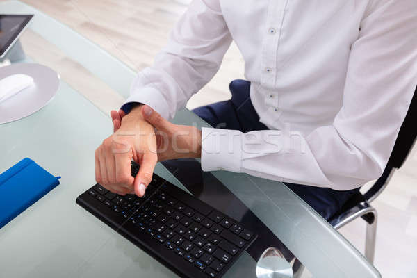 Businessman Holding Painful Wrist Stock photo © AndreyPopov