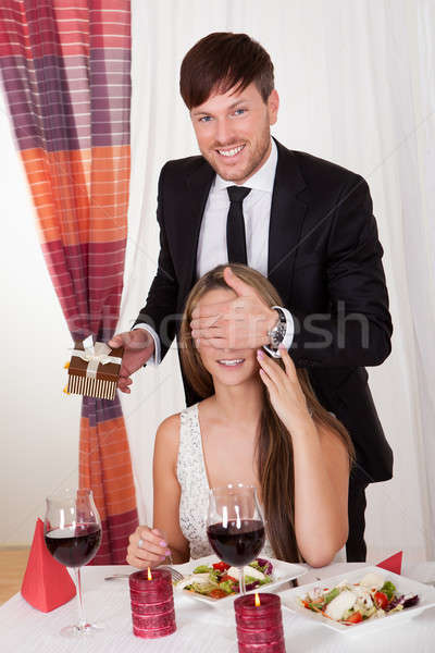 Man surprising his wife with a gift Stock photo © AndreyPopov