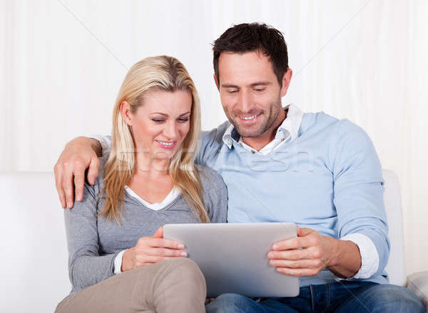 Couple looking at a tablet together Stock photo © AndreyPopov
