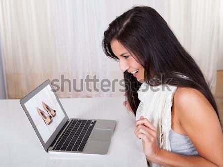 Woman shopping online for shoes Stock photo © AndreyPopov