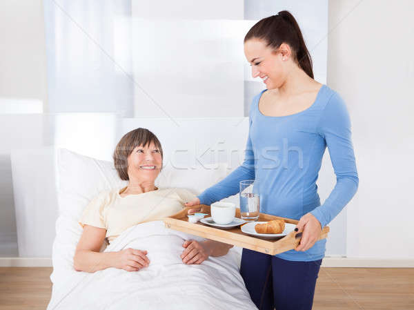 Caregiver Serving Breakfast To Senior Woman Stock photo © AndreyPopov