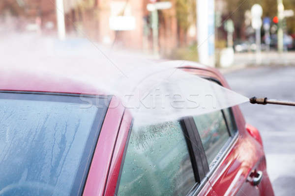 Hose Spraying Water On Car Stock photo © AndreyPopov
