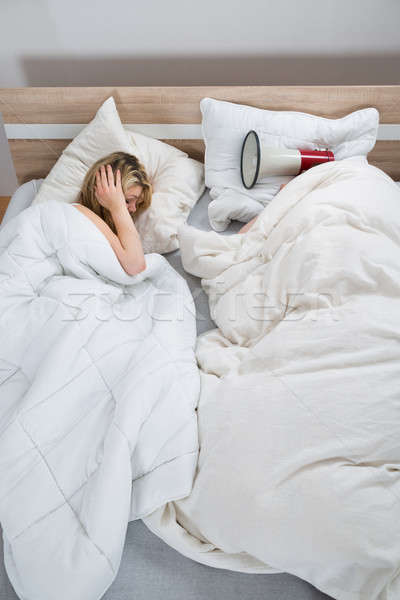 Couple With Duvet In Bedroom Stock photo © AndreyPopov
