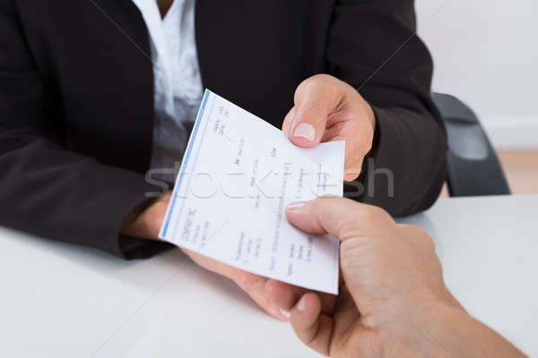 Businessperson Hands Giving Cheque To Other Person Stock photo © AndreyPopov