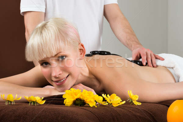Young Woman Receiving Hot Stone Therapy Stock photo © AndreyPopov