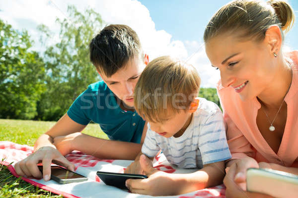 Parents With Their Son Using Smartphone Stock photo © AndreyPopov