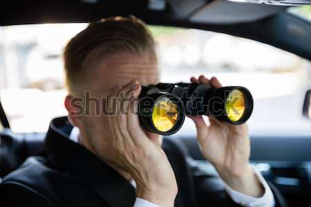 Male Looking Through Binoculars Stock photo © AndreyPopov