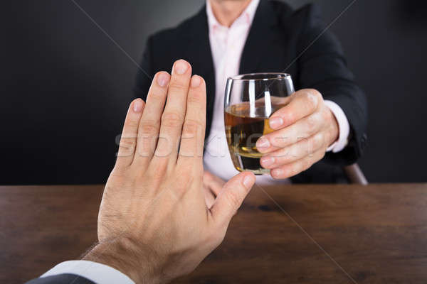 Businessman Hand Rejecting A Glass Of Whiskey Stock photo © AndreyPopov