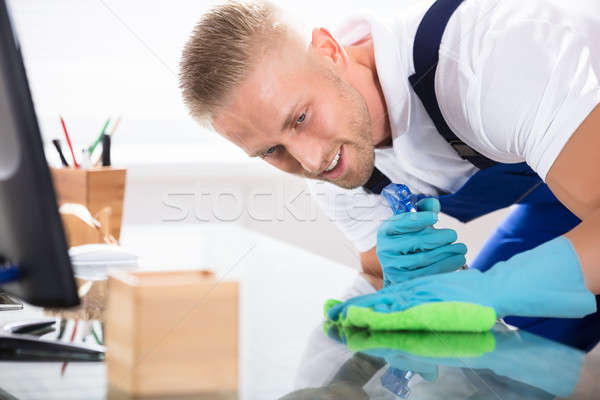 Close-up Of A Janitor Cleaning Desk With Cloth Stock photo © AndreyPopov