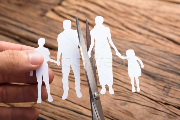 Hand Cutting Paper Family Over Wooden Table Stock photo © AndreyPopov