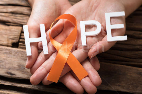 Hand Showing Ribbon With Hope Text Stock photo © AndreyPopov