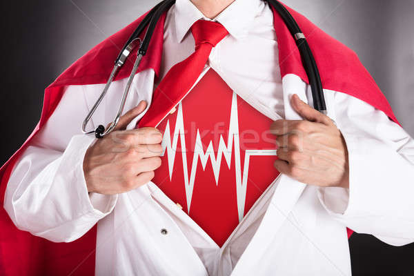 Stock photo: Superhero Doctor Showing Heartbeat Sign