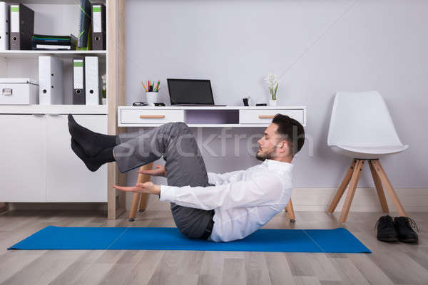 Side View Of A Businessman Doing Exercise Stock photo © AndreyPopov