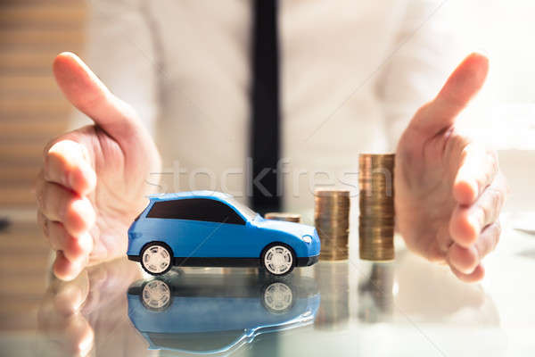 Person Protecting Increasing Stacked Coins And Car Stock photo © AndreyPopov