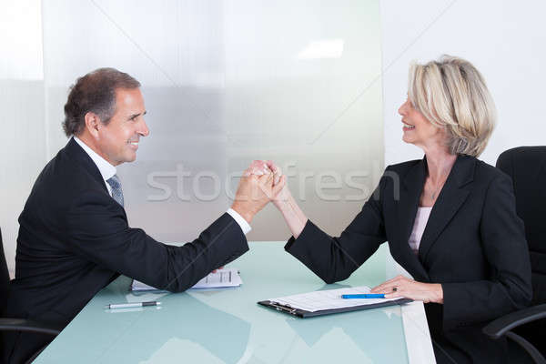 Stock photo: Mature Businessman And Businesswoman Holding Hand