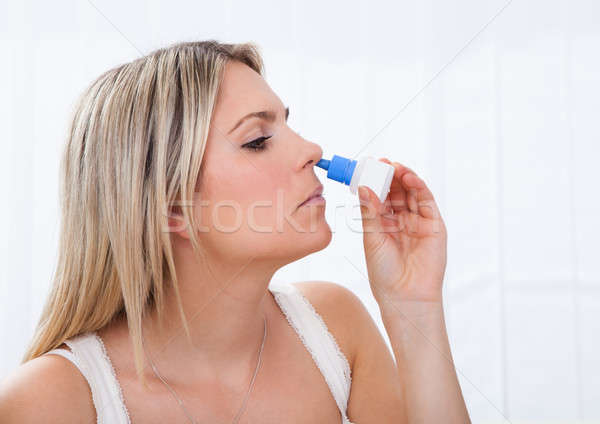 Woman using nasal spray Stock photo © AndreyPopov