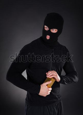 Masked thug or criminal with a crowbar Stock photo © AndreyPopov