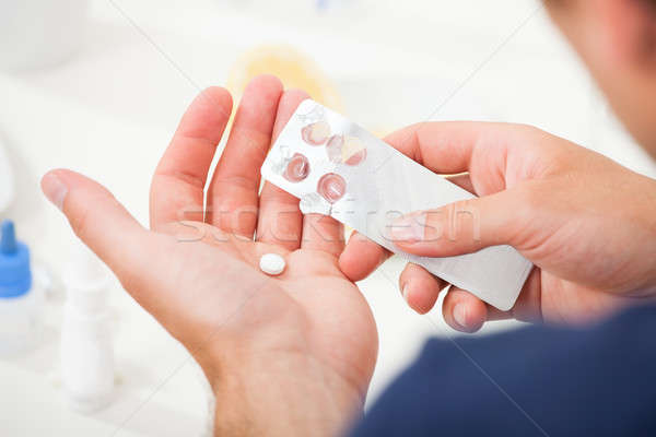 Man Taking Pill Out From Blister Pack Stock photo © AndreyPopov