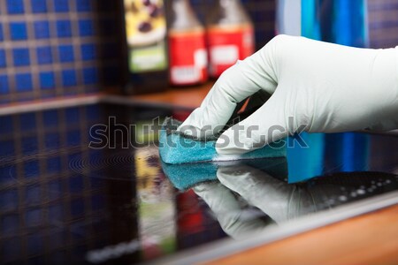 Person Cleaning Induction Cooker Stock photo © AndreyPopov