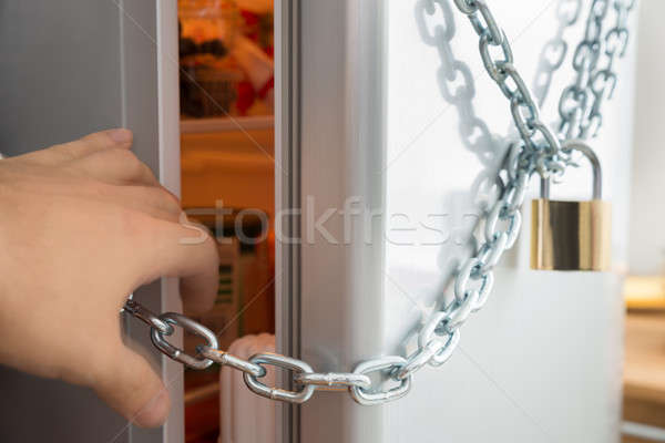 Person Trying To Open Locked Fridge Stock photo © AndreyPopov