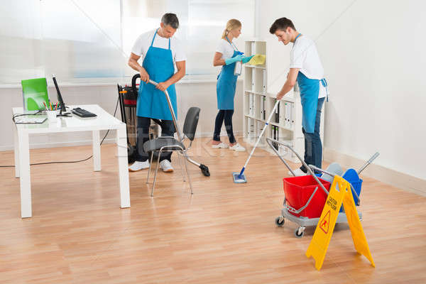 Janitors In Blue Apron Cleaning Office Stock photo © AndreyPopov