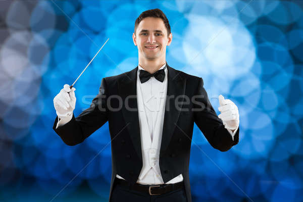 Happy Music Conductor Holding Baton Stock photo © AndreyPopov