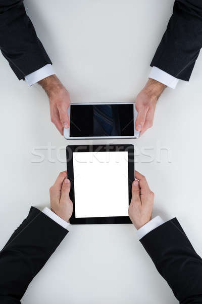 Businessmen Using Digital Tablets At Table In Office Stock photo © AndreyPopov