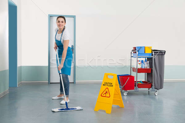Female Janitor Mopping Corridor Stock photo © AndreyPopov