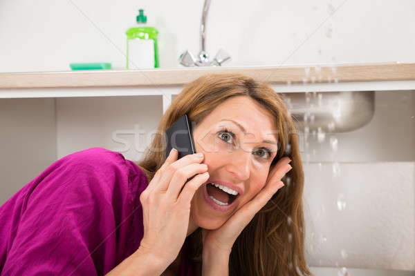 Close-up Of Woman Calling To Plumber Stock photo © AndreyPopov