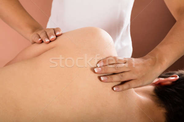 Man Getting Shoulder Massage From Therapist Stock photo © AndreyPopov