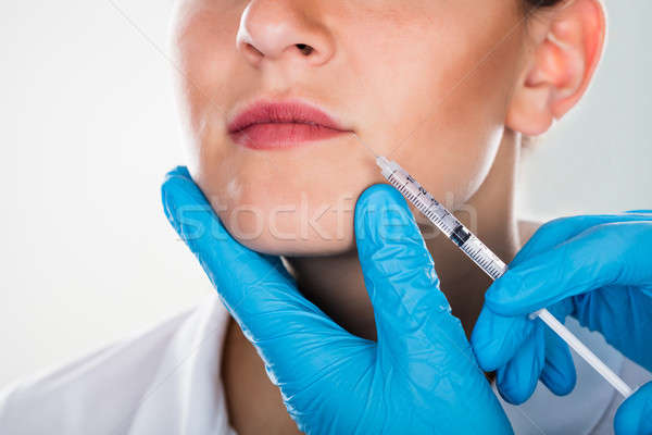 Mulher cosmético injeção lábio mulher jovem Foto stock © AndreyPopov