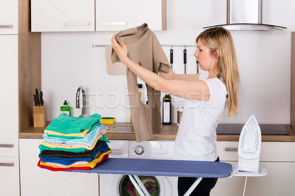 Shocked Woman Looking At Burnt T-shirt Stock photo © AndreyPopov