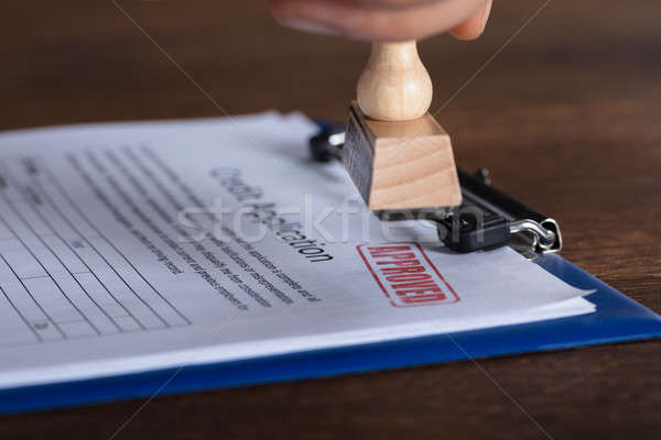 Person's Hand Stamping On Approved Form Stock photo © AndreyPopov