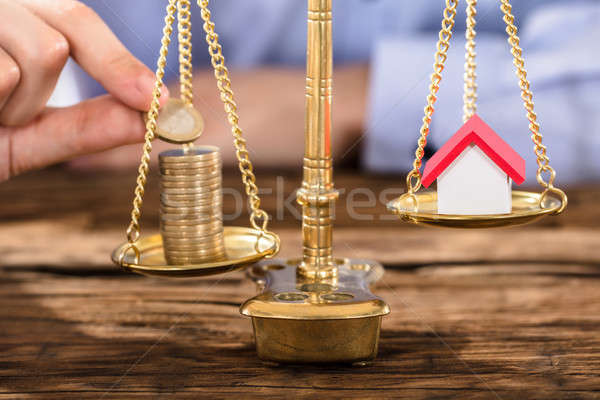 Person Protecting Justice Scale With Coins And House Model Stock photo © AndreyPopov