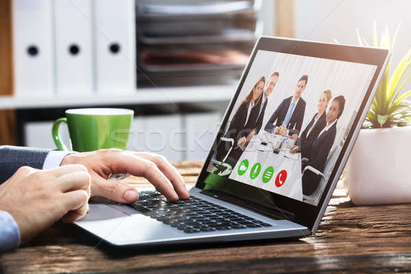 Businessperson Video Conferencing With Colleagues On Laptop Stock photo © AndreyPopov