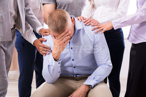 Group Of People Consoling Upset Man Stock photo © AndreyPopov