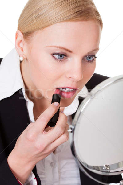 Attractive businesswoman applying lipstick Stock photo © AndreyPopov