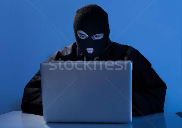 Criminal Using Laptop To Hack Online Account Stock photo © AndreyPopov