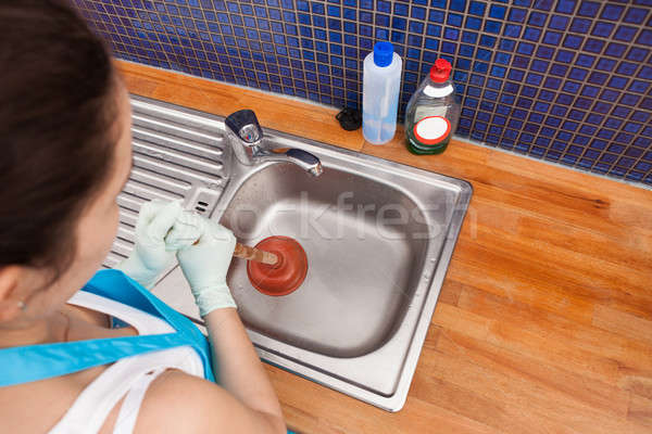 Woman Using Plunger Stock photo © AndreyPopov