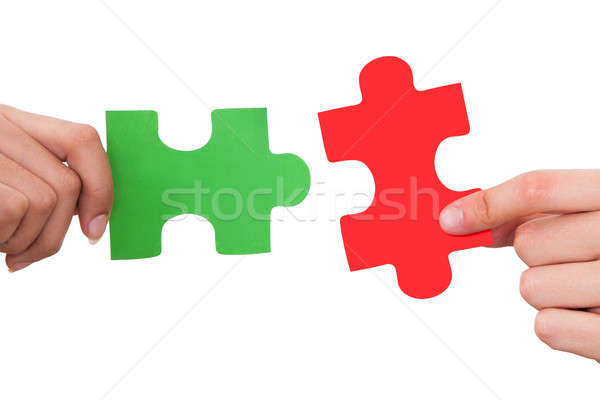 Hands Joining Jigsaw Puzzle Pieces Stock photo © AndreyPopov