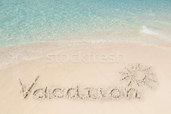 Vacation Written On Sand By Sea Stock photo © AndreyPopov